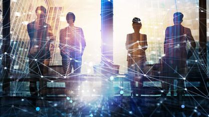 Business team silhouettes against city skyline with network overlay